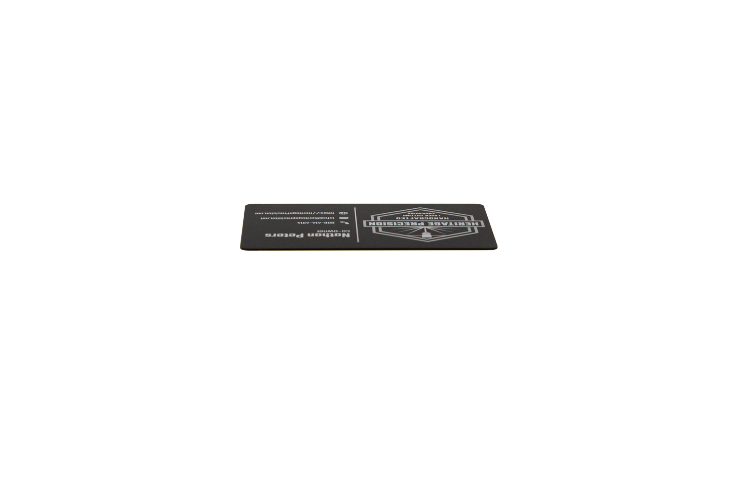 Black business card with white text laying down showing black edge