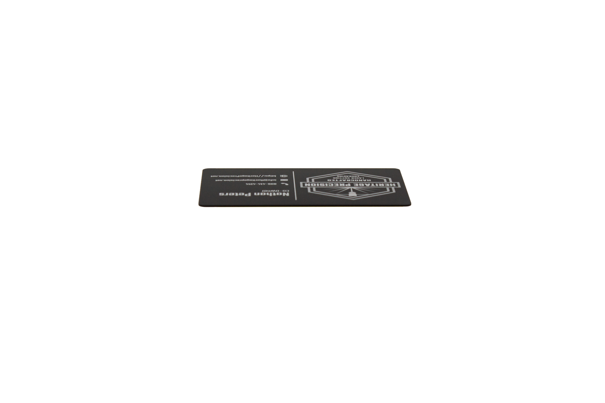 Black business card with white text laying down showing black edge